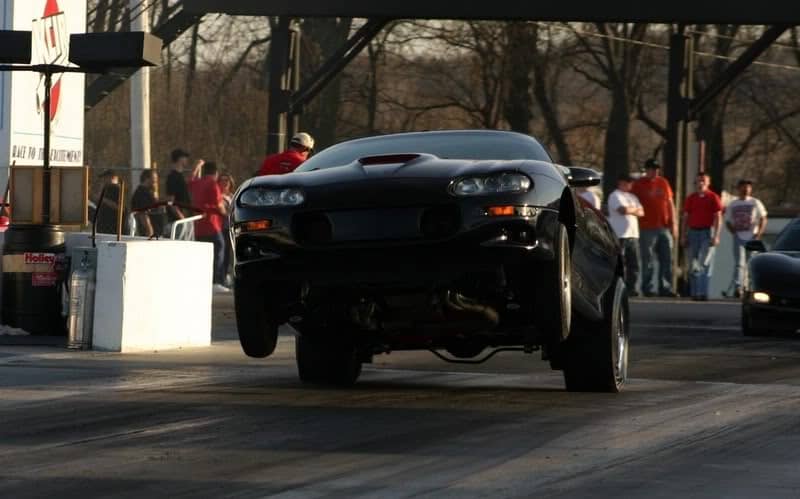 4th generation Chevy Camaro doing wheel stand at race track
