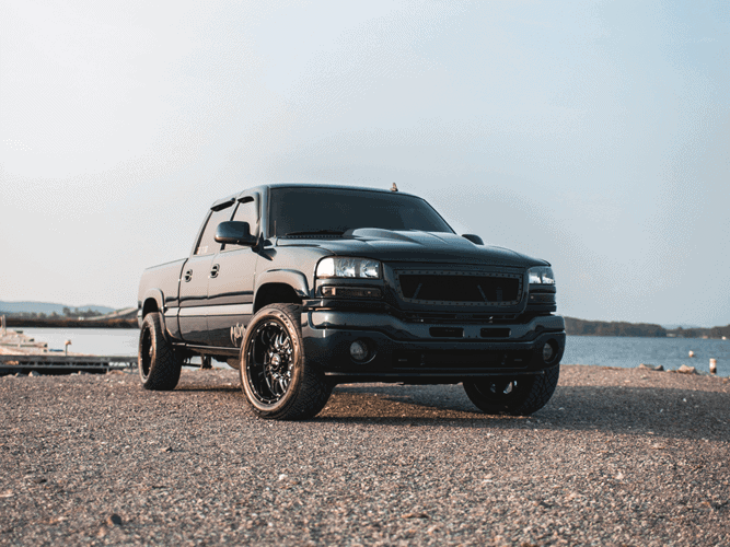 black GMC Sierra sitting by the lake